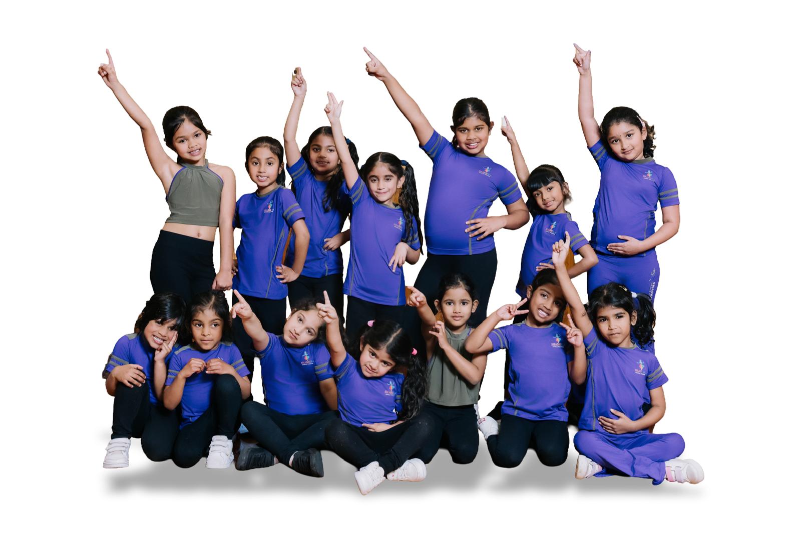 Children at SHEEDance smiling and striking dance poses
