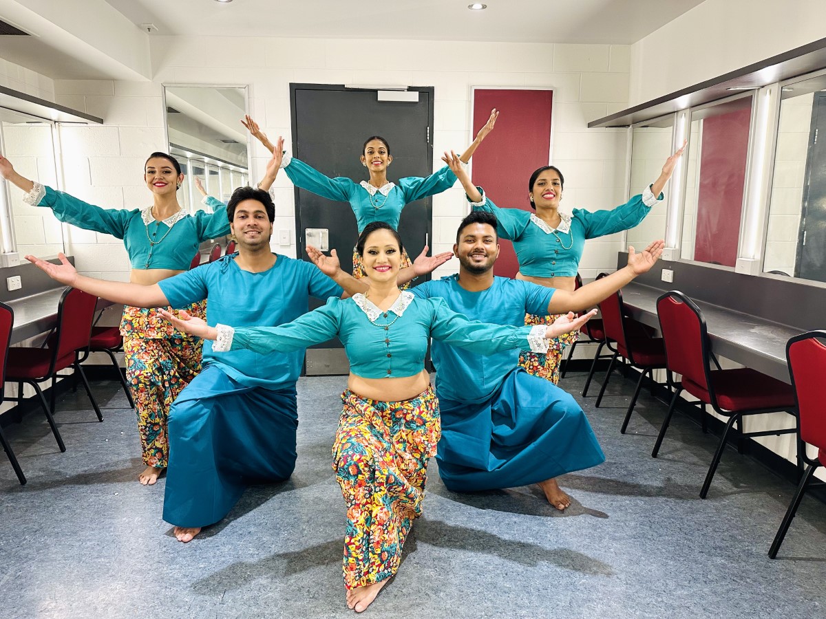 Shashila Dance Troupe performers in turquoise costumes
